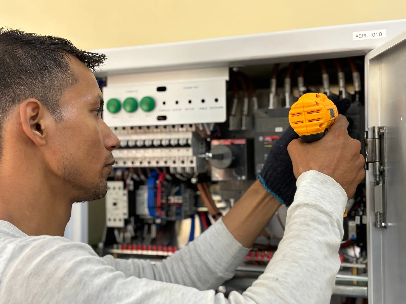 An electrician working on a commercial control panel, for panel upgrade in Toronto