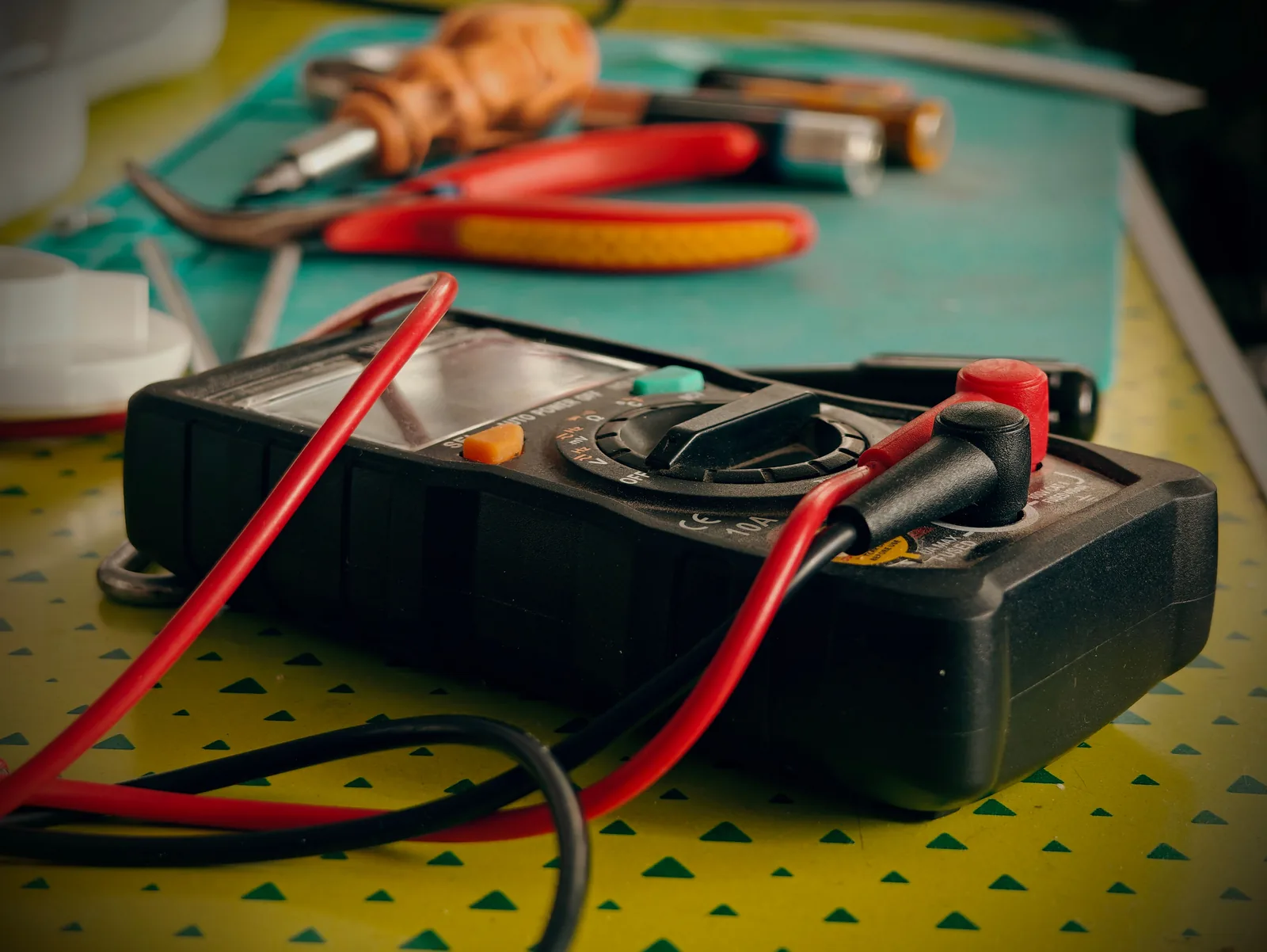 A multimeter and hand tools ready for a diagnostic visit, for electrician in Toronto