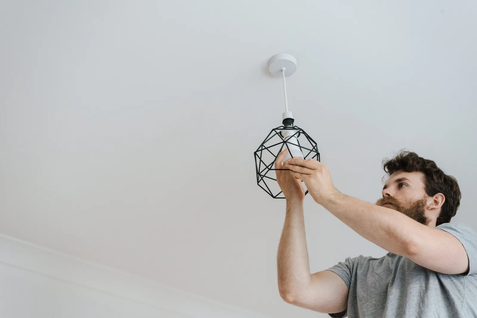 Fitting a lamp into a pendant fixture, for ev charger installation in Toronto